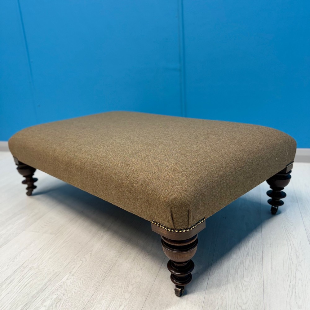 Large Harris Tweed footstool on castors