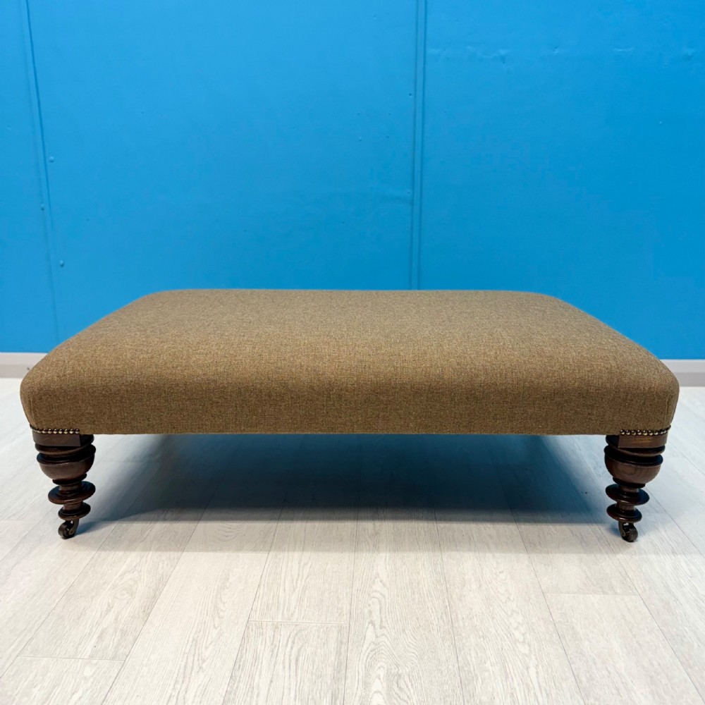 Large Harris Tweed footstool on castors View III