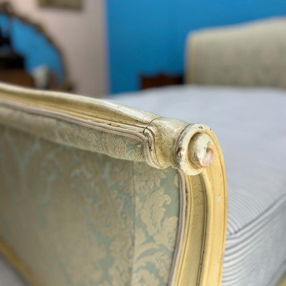 A king-size French bed frame featuring a carved cream-painted timber frame upholstered in green damask fabric with a scroll-end footboard. View VII