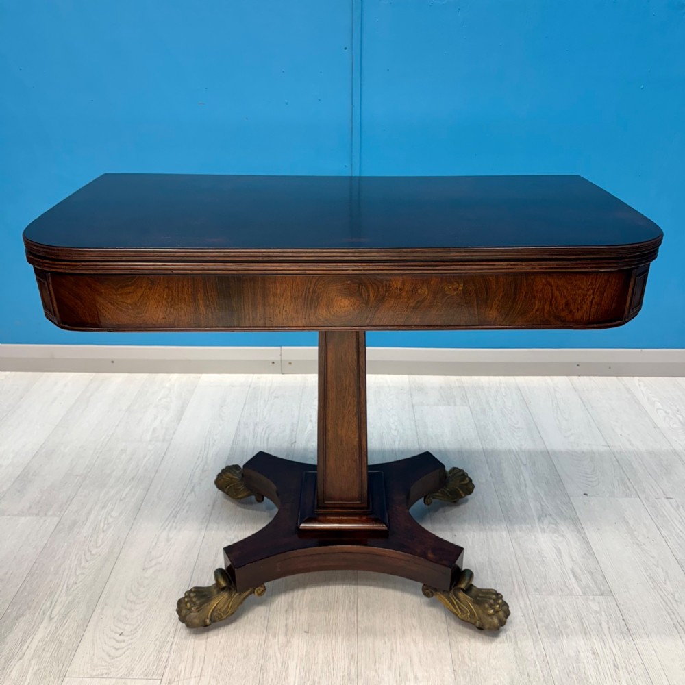 Regency rosewood card table on brass lions paw feet