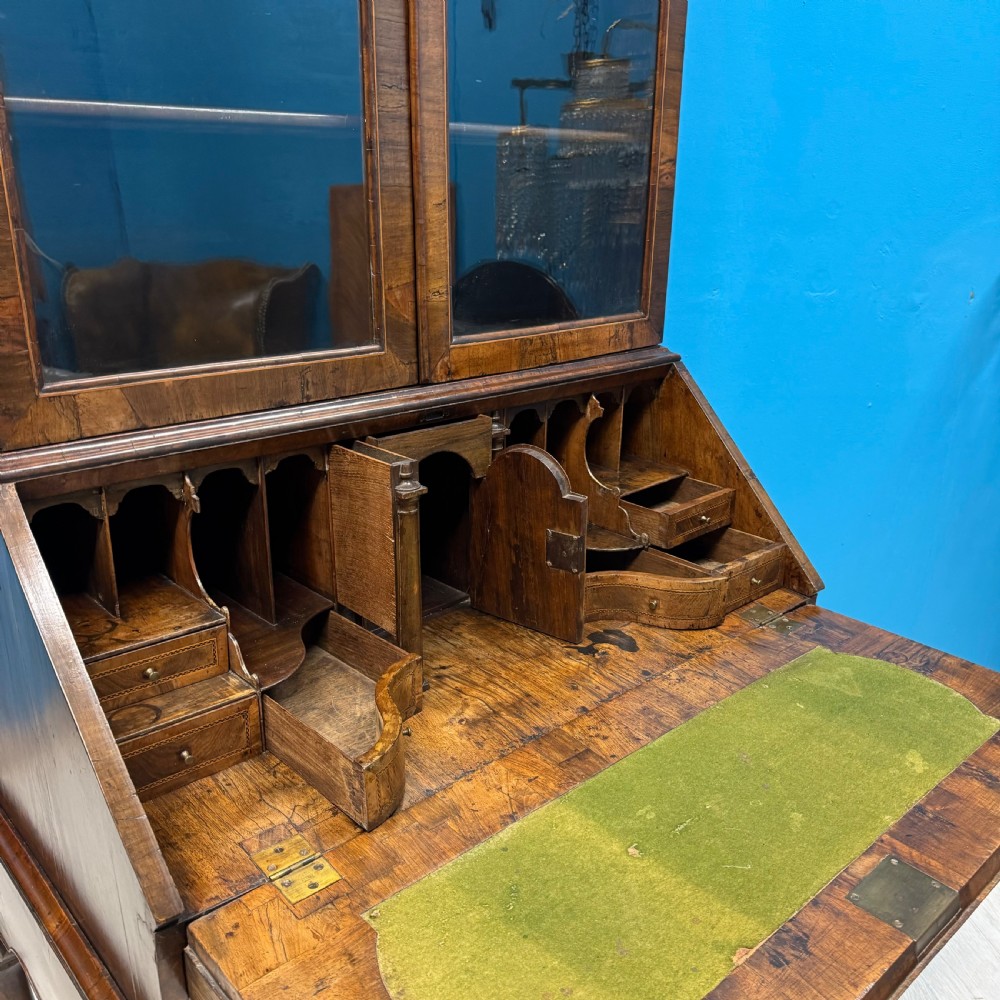A George II walnut bureau bookcase on stand featuring a two-door glazed upper display cabinet and a slant-front writing desk over cabriole legs. View VII