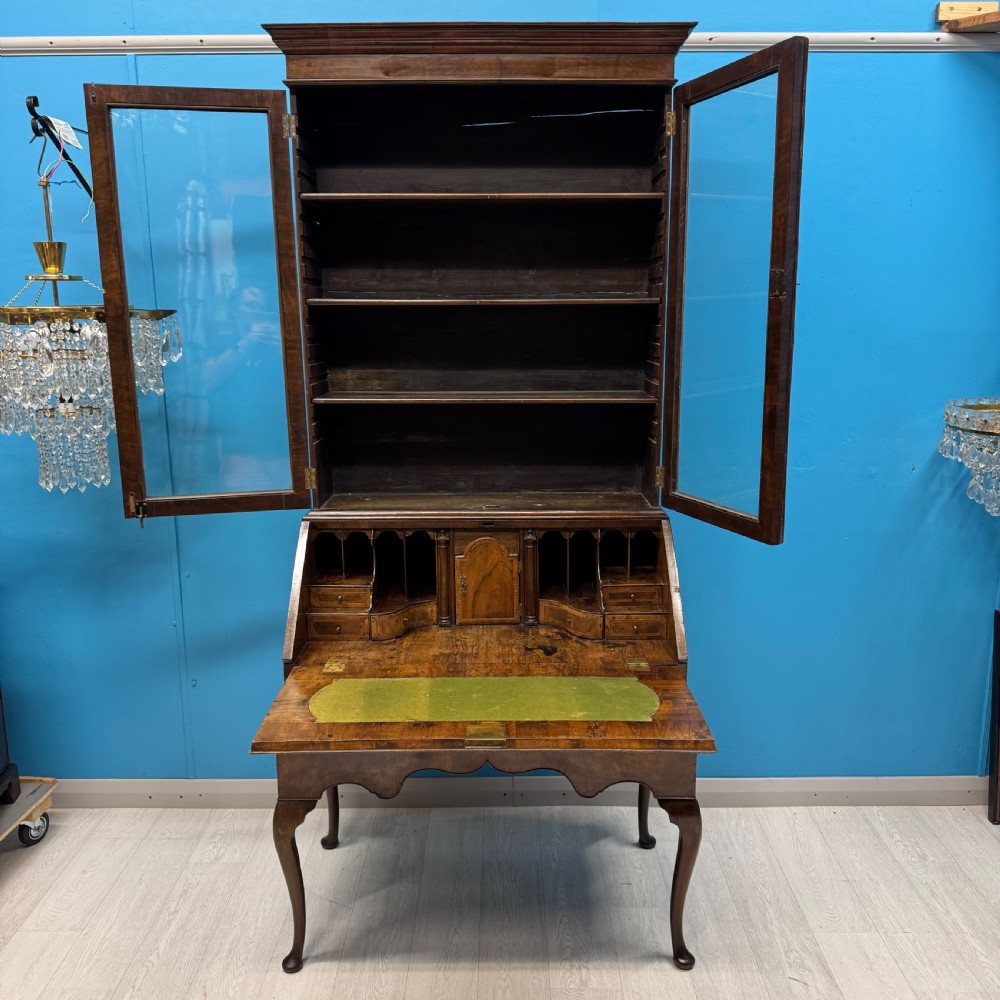 A George II walnut bureau bookcase on stand featuring a two-door glazed upper display cabinet and a slant-front writing desk over cabriole legs. View XI