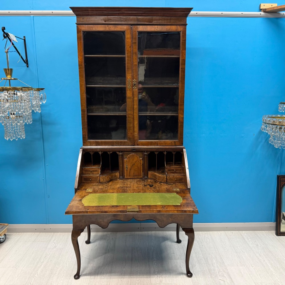 A George II walnut bureau bookcase on stand featuring a two-door glazed upper display cabinet and a slant-front writing desk over cabriole legs. View XII