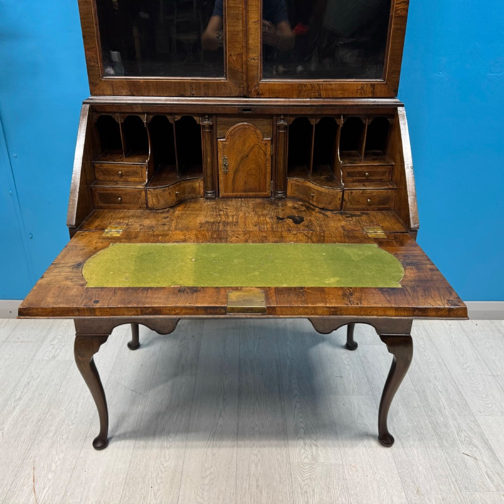 A George II walnut bureau bookcase on stand featuring a two-door glazed upper display cabinet and a slant-front writing desk over cabriole legs. View XIV