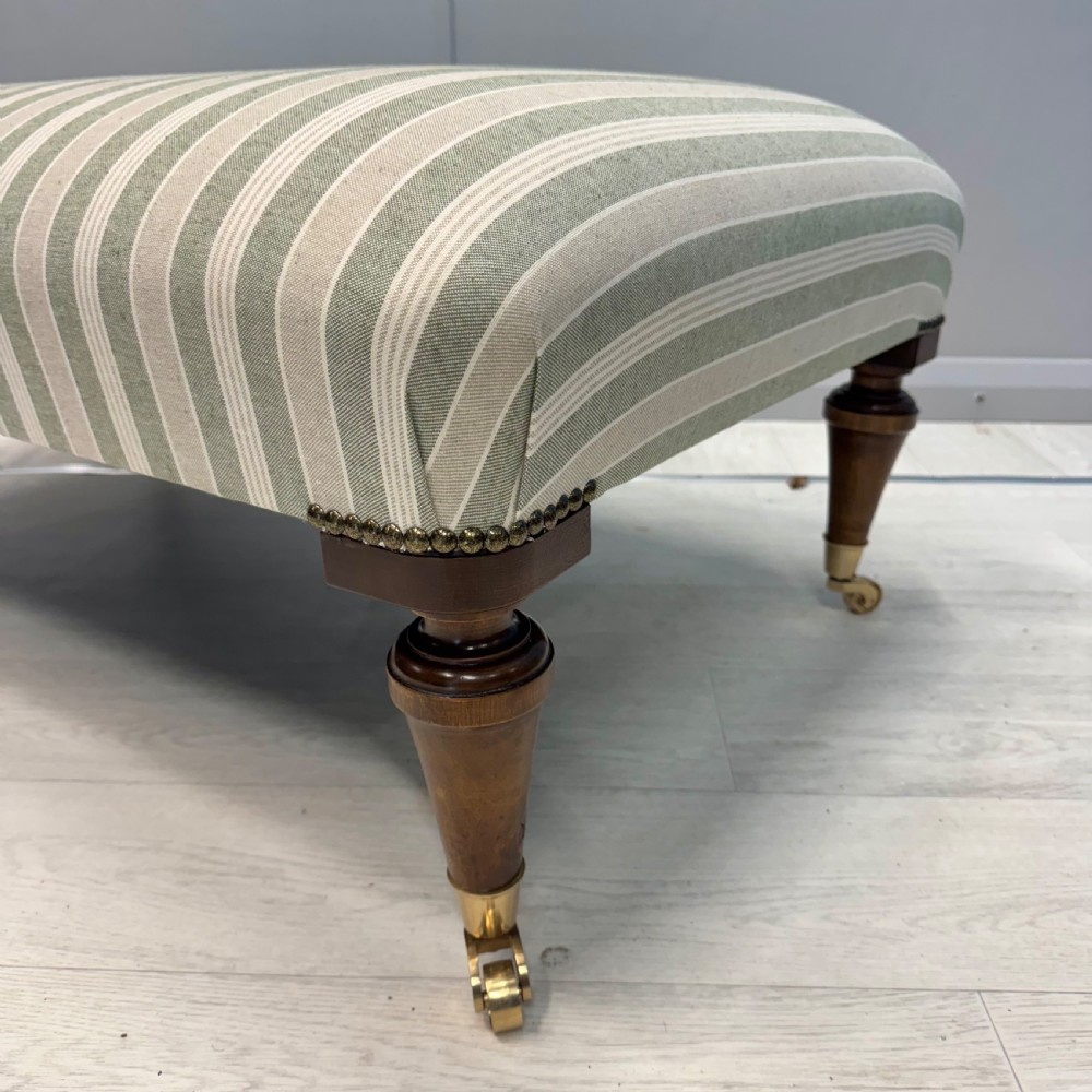 Upholstered French footstool on brass castors View IV