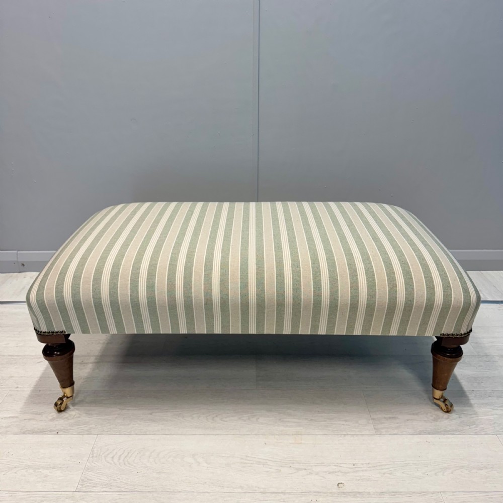 Upholstered French footstool on brass castors View VI