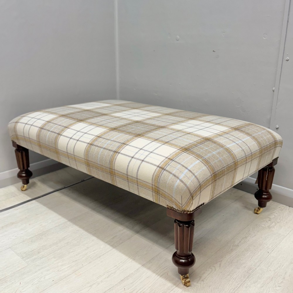 Large newly upholstered footstool on castors