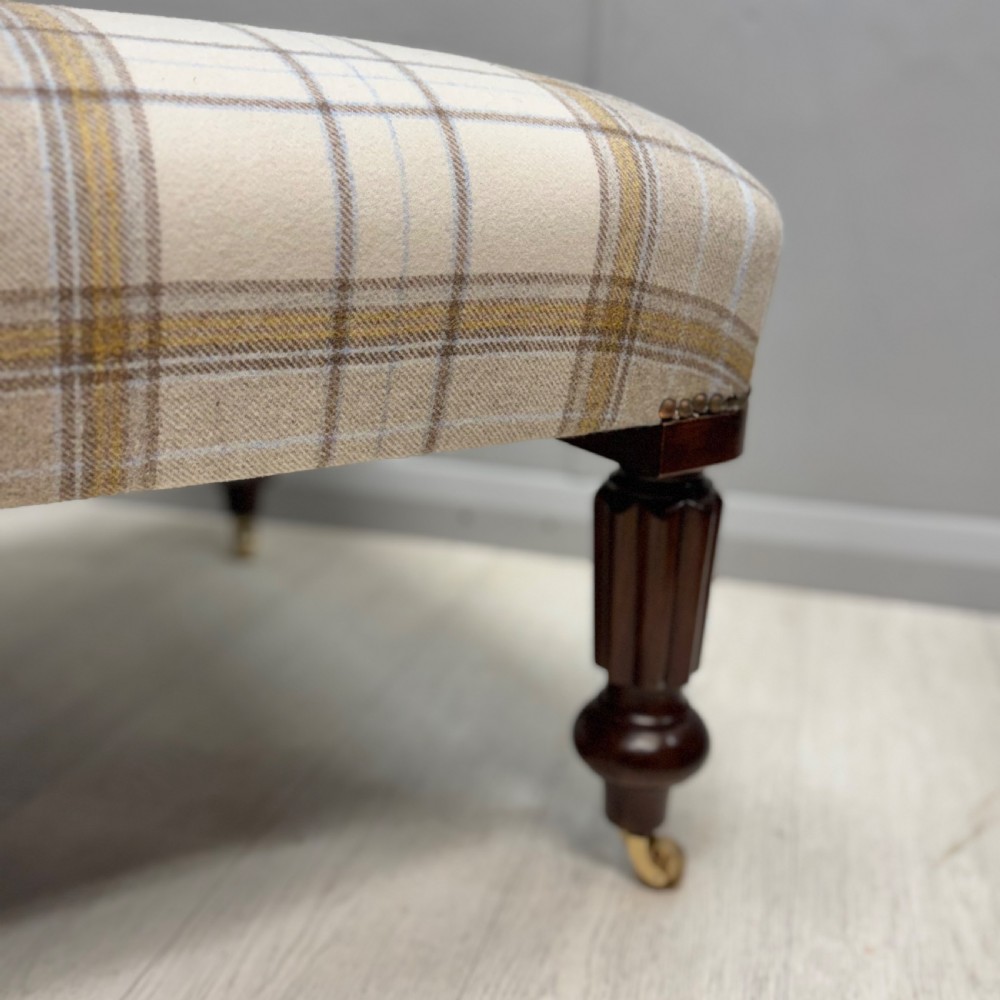 Large newly upholstered footstool on castors View II