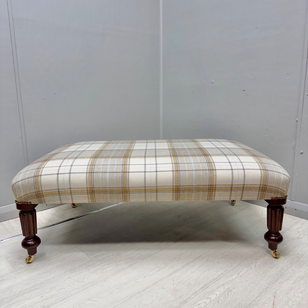 Large newly upholstered footstool on castors View IV