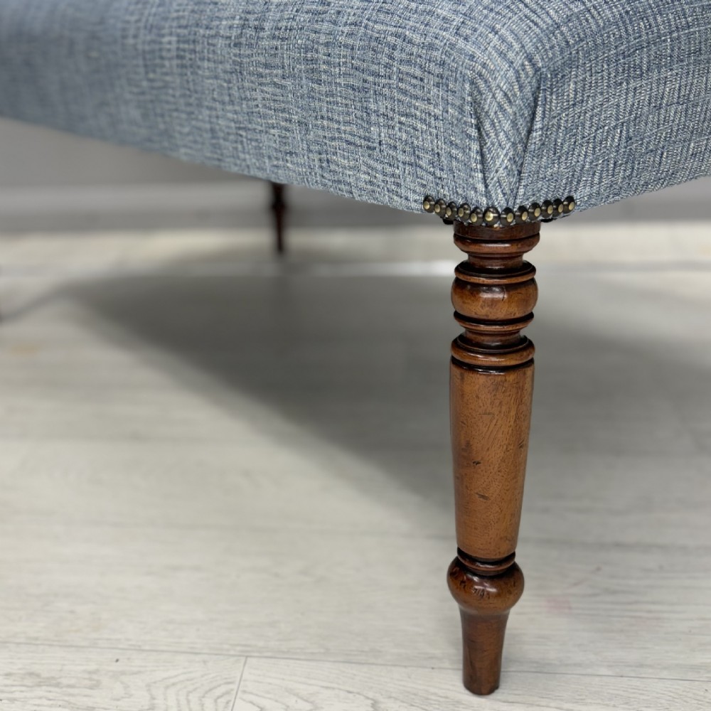 Newly upholstered turned leg footstool  View II