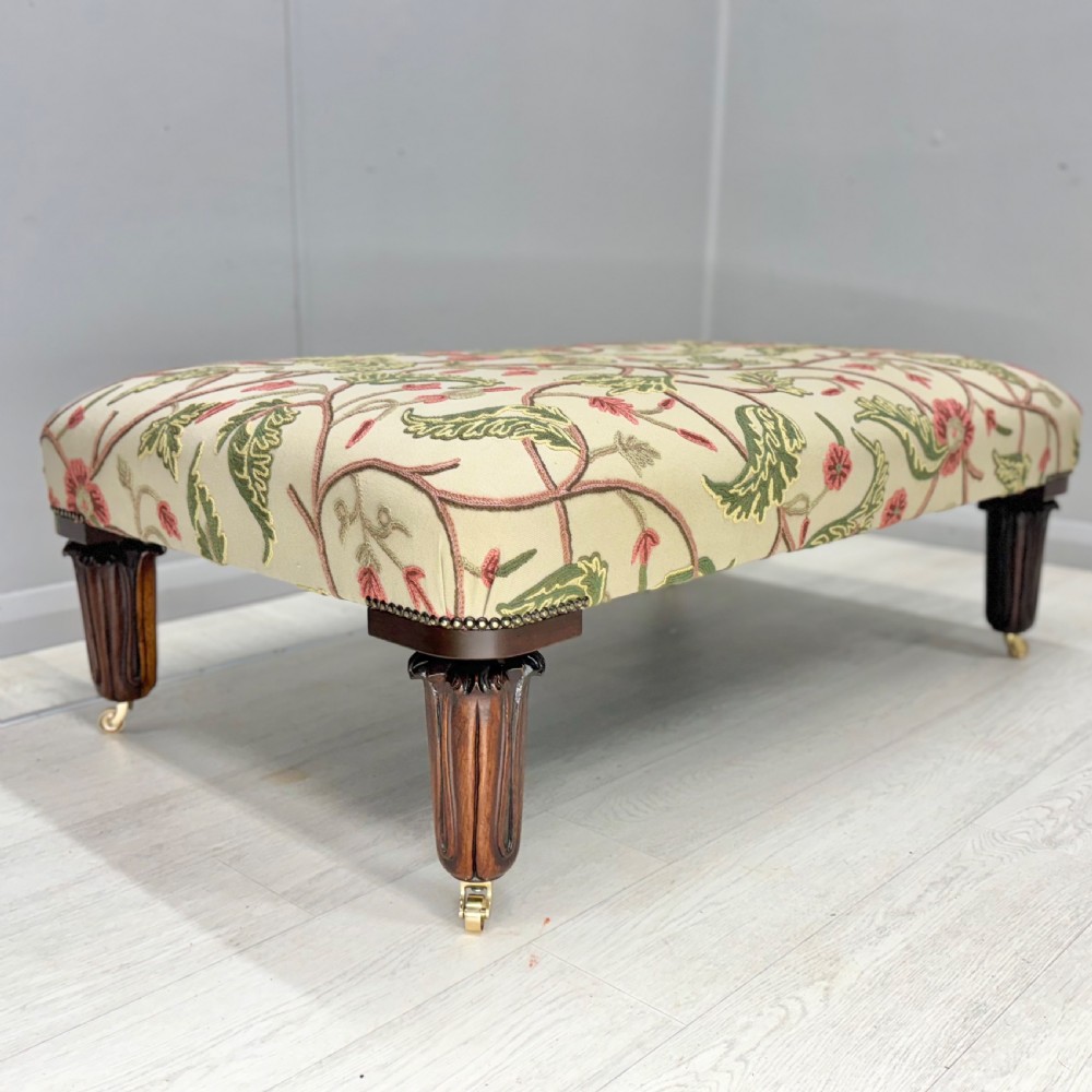 Large newly upholstered footstool on George IV legs