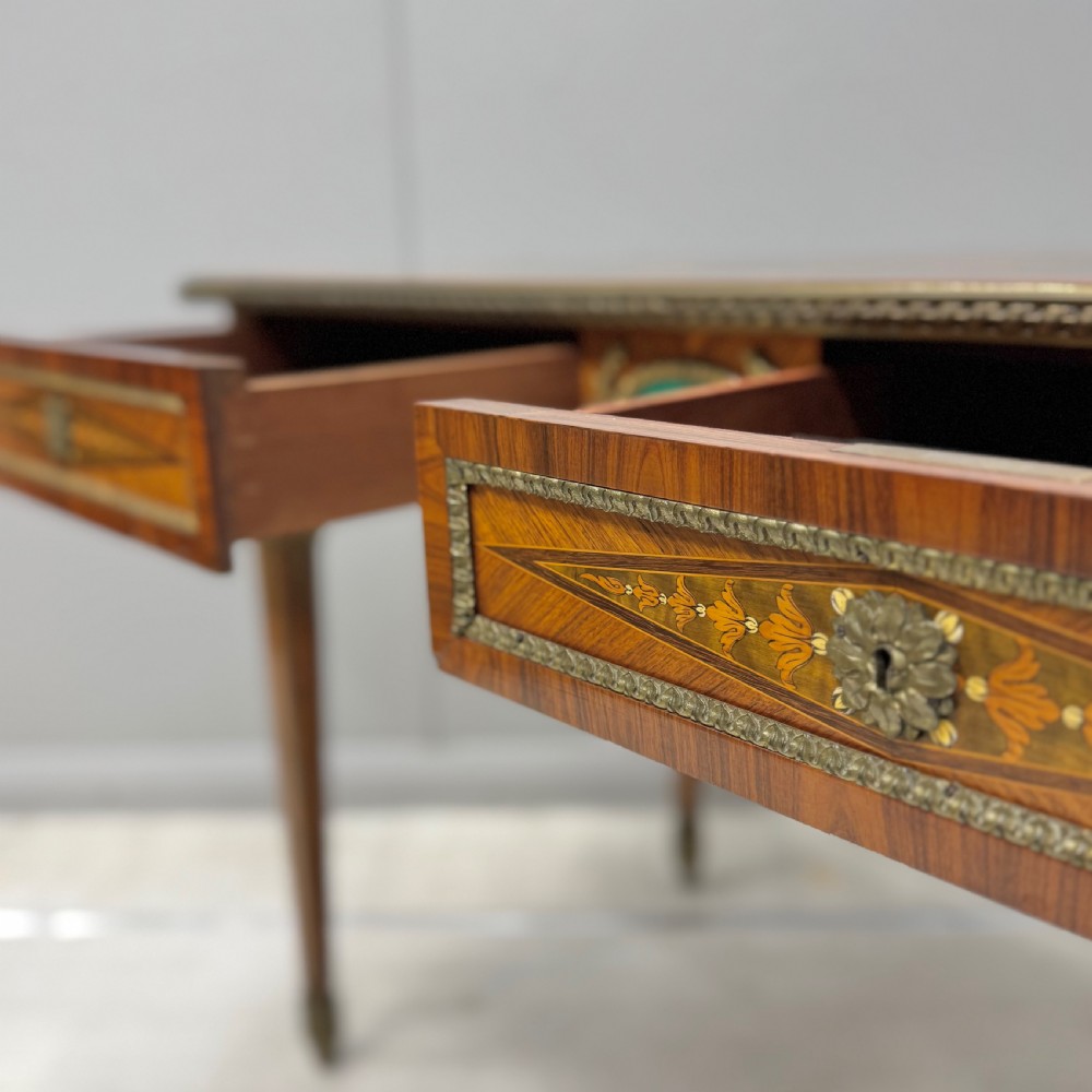 A French Louis XVI style kingwood centre table featuring intricate floral marquetry, brass mounts, a central porcelain plaque, and tapered square legs. View V