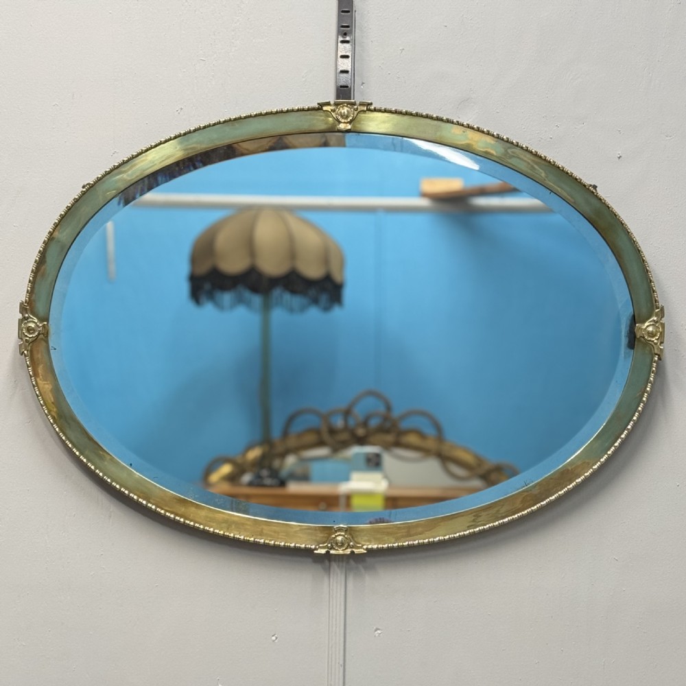 Edwardian brass oval mirror with bevelled glass