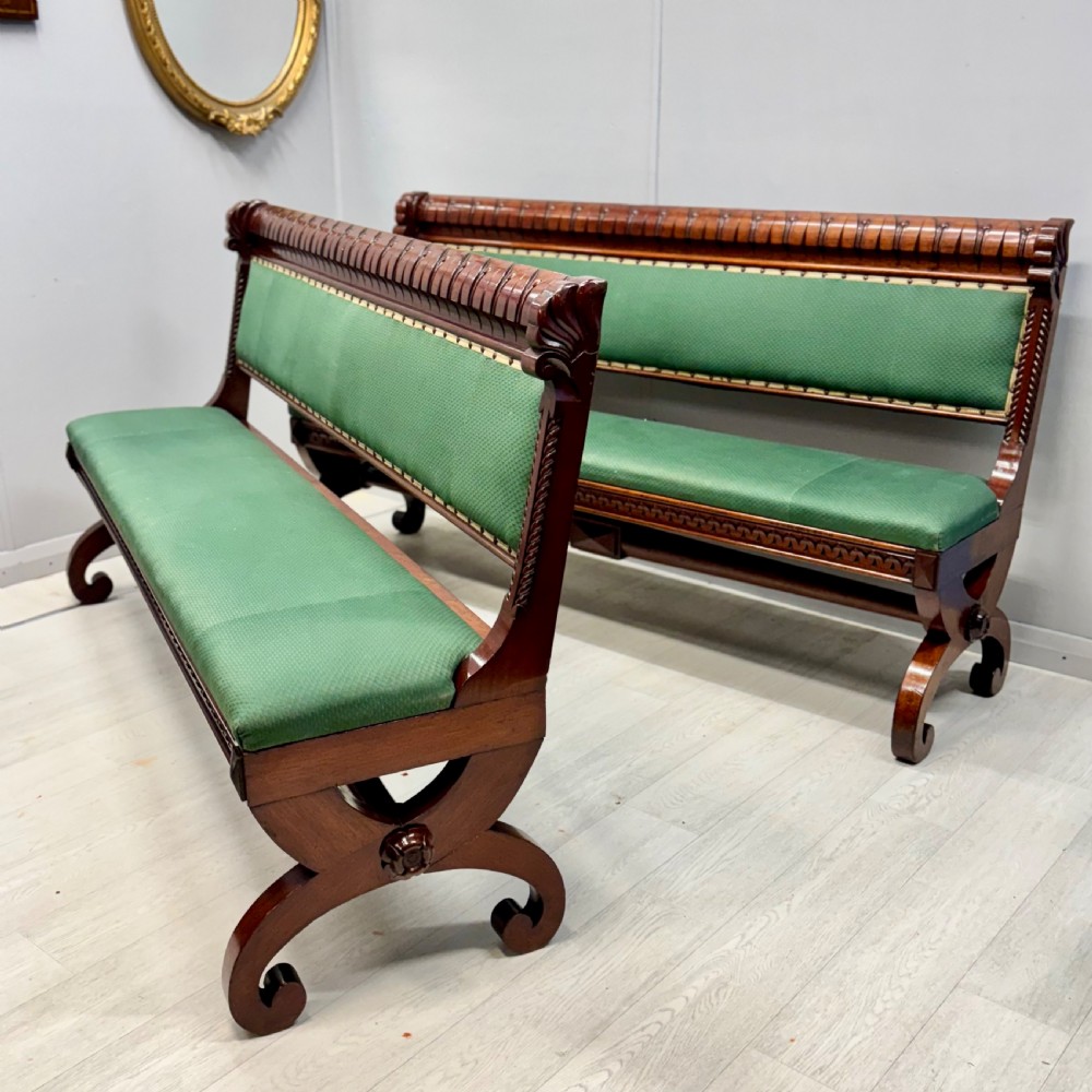 A pair of 19th-century carved mahogany benches featuring green upholstered seats and backrests supported by scrolled legs. View VI