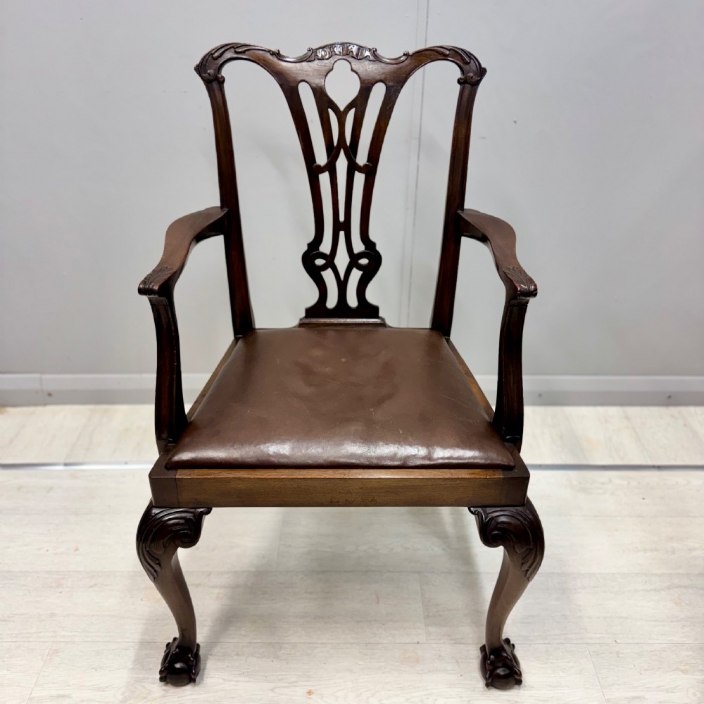 A set of eight Georgian style mahogany dining chairs featuring pierced back splats, brown leather seats, and cabriole legs ending in ball and claw feet. View IV
