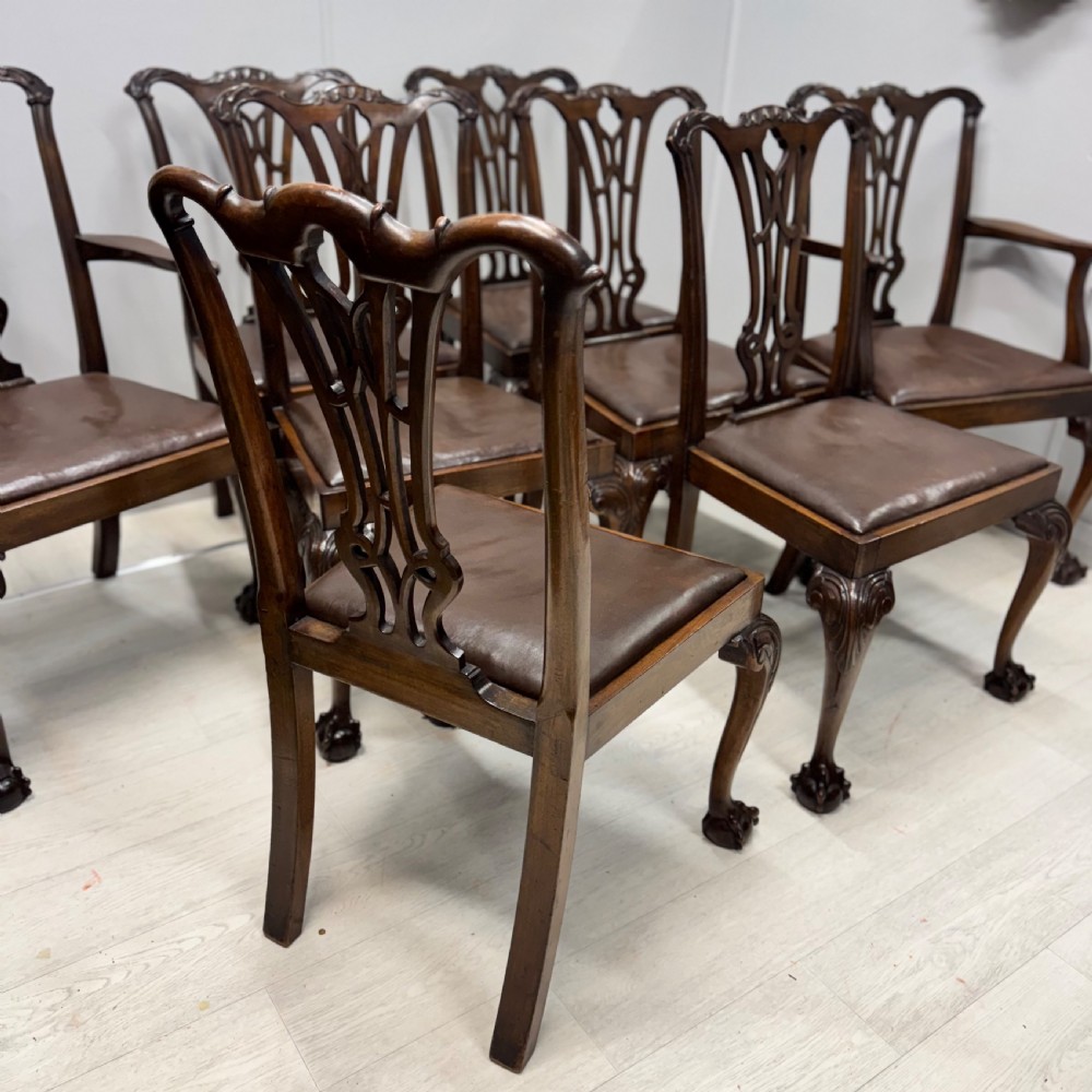 A set of eight Georgian style mahogany dining chairs featuring pierced back splats, brown leather seats, and cabriole legs ending in ball and claw feet. View VIII