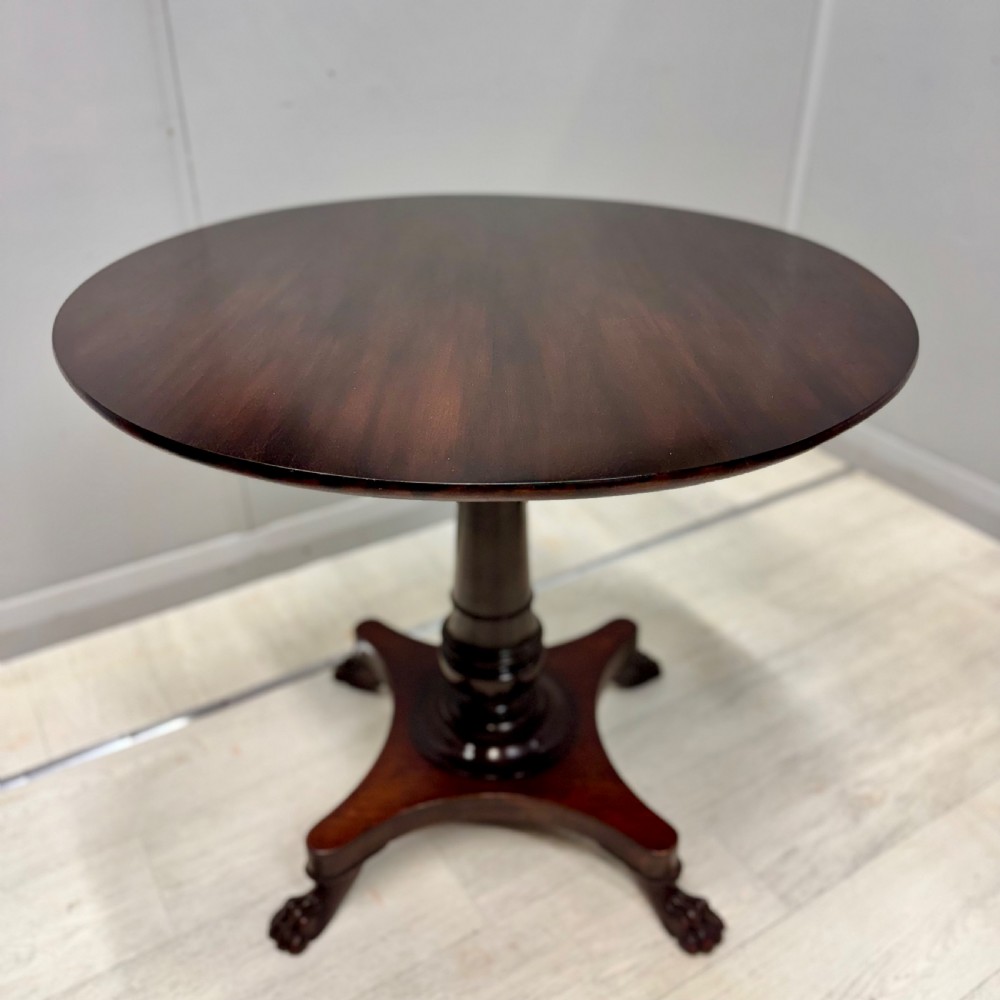 A round dark mahogany pedestal side table featuring a turned central column and a four-legged base with carved lion paw feet. View IV