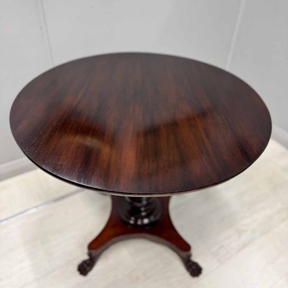 A round dark mahogany pedestal side table featuring a turned central column and a four-legged base with carved lion paw feet. View II