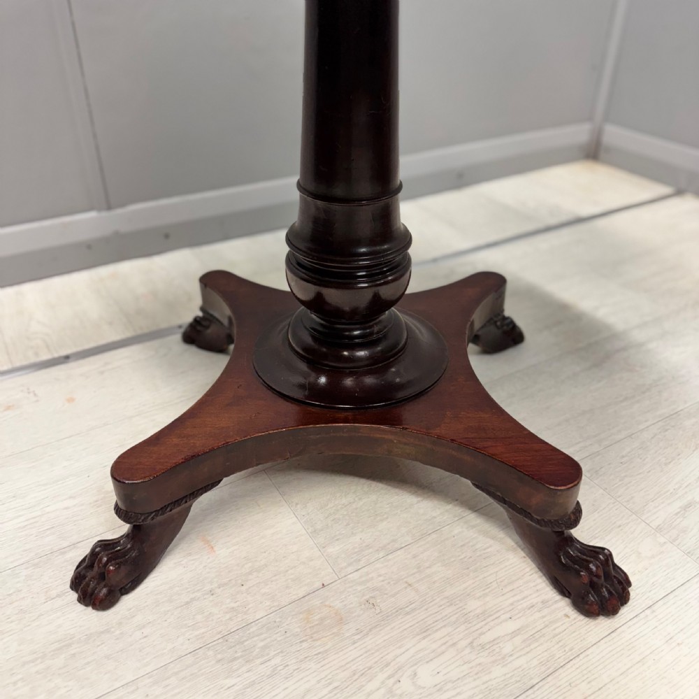 A round dark mahogany pedestal side table featuring a turned central column and a four-legged base with carved lion paw feet. View III