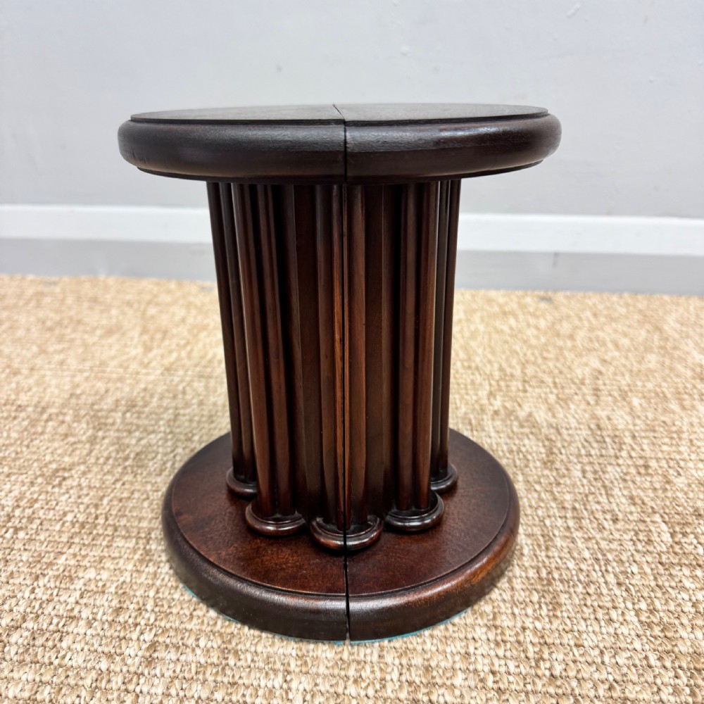A pair of dark mahogany semi-circular bookends shaped like classical fluted columns. View II