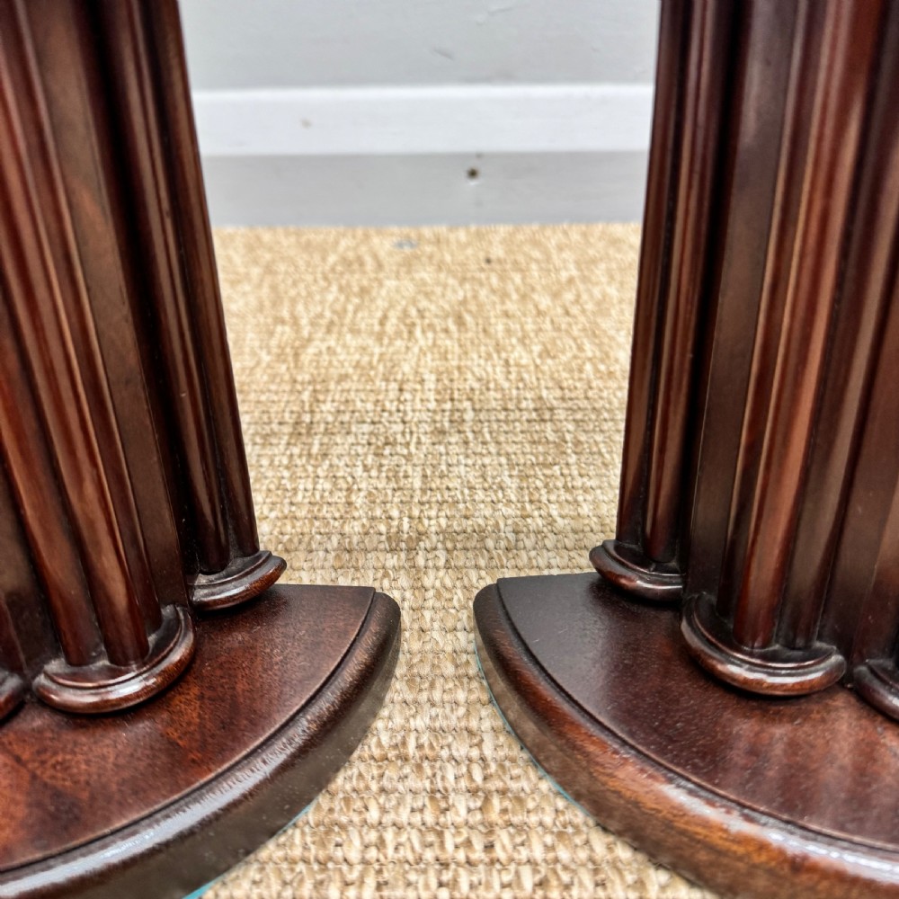 A pair of dark mahogany semi-circular bookends shaped like classical fluted columns. View VI