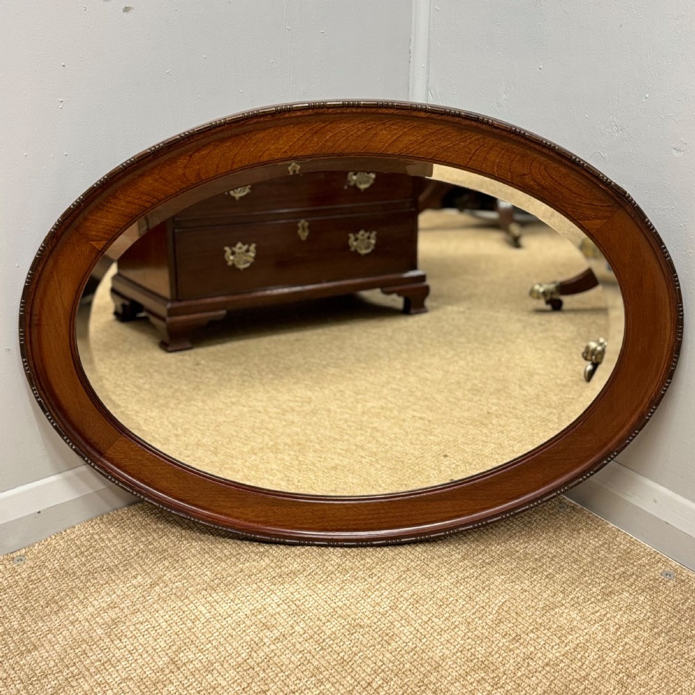 Oval mahogany framed mirror with bevelled glass