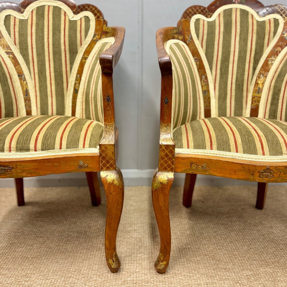 A pair of satinwood armchairs featuring hand-painted Chinoiserie detail, cabriole legs, and striped green, beige, and red fabric upholstery. View II