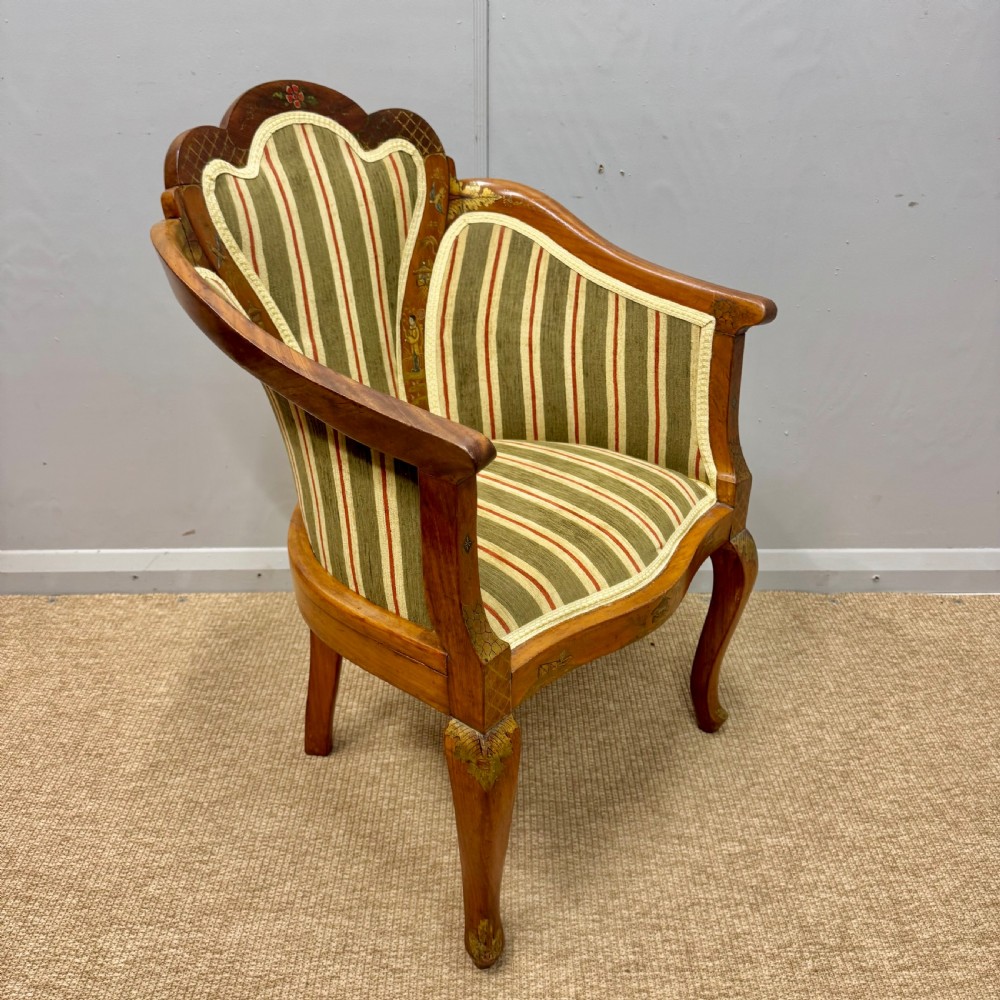 A pair of satinwood armchairs featuring hand-painted Chinoiserie detail, cabriole legs, and striped green, beige, and red fabric upholstery. View IV