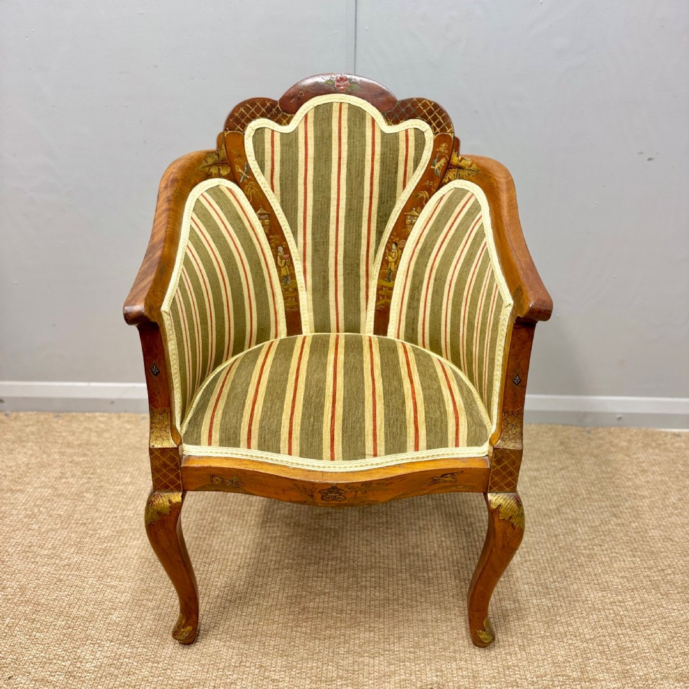 A pair of satinwood armchairs featuring hand-painted Chinoiserie detail, cabriole legs, and striped green, beige, and red fabric upholstery. View V