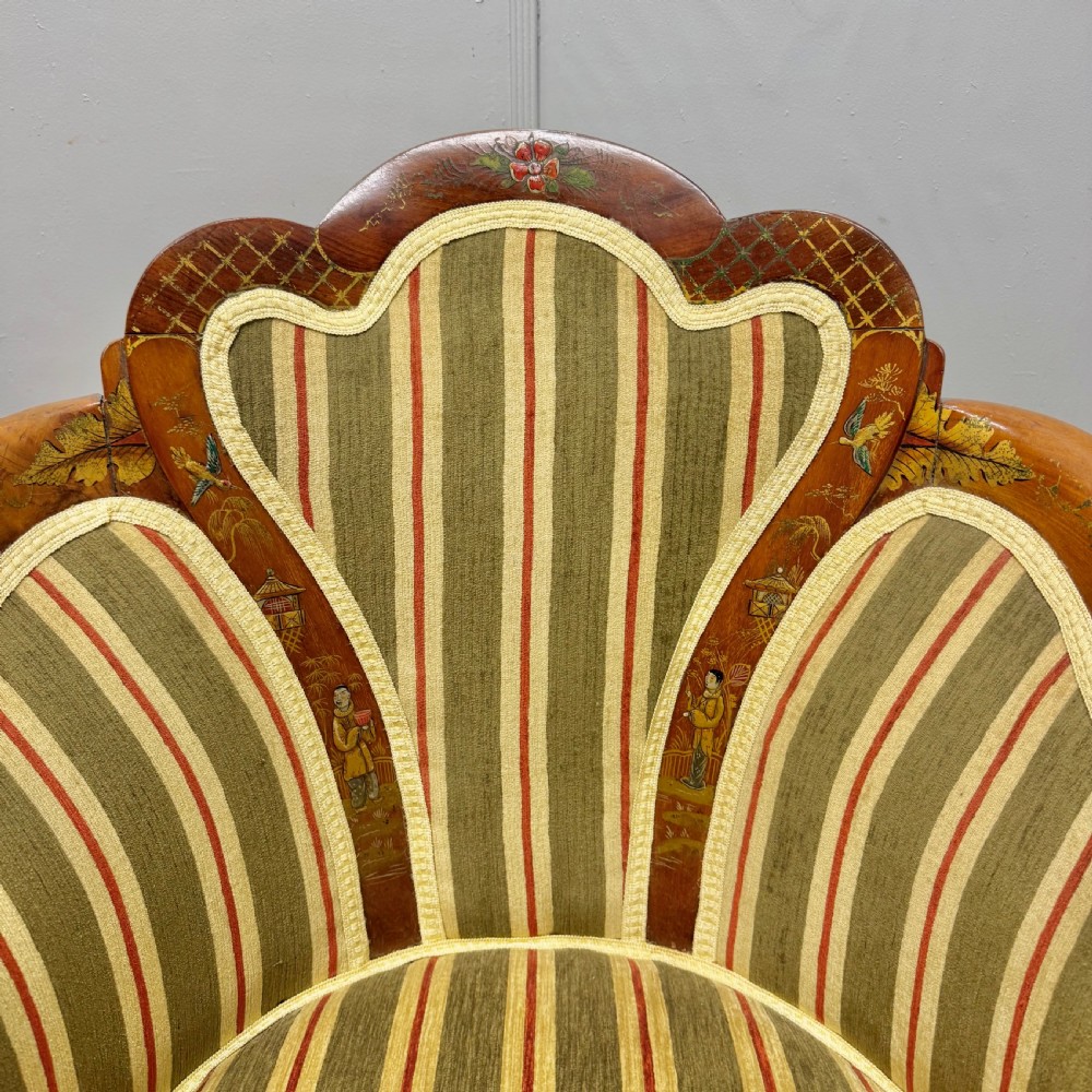 A pair of satinwood armchairs featuring hand-painted Chinoiserie detail, cabriole legs, and striped green, beige, and red fabric upholstery. View VI