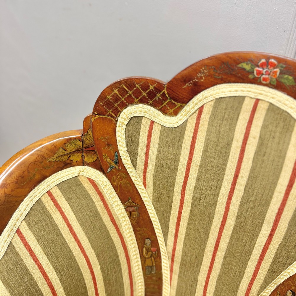 A pair of satinwood armchairs featuring hand-painted Chinoiserie detail, cabriole legs, and striped green, beige, and red fabric upholstery. View VII