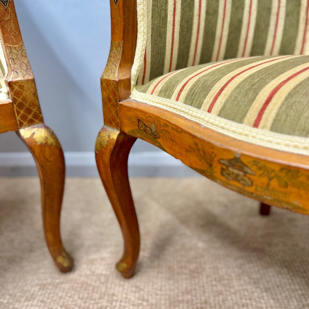 A pair of satinwood armchairs featuring hand-painted Chinoiserie detail, cabriole legs, and striped green, beige, and red fabric upholstery. View VIII