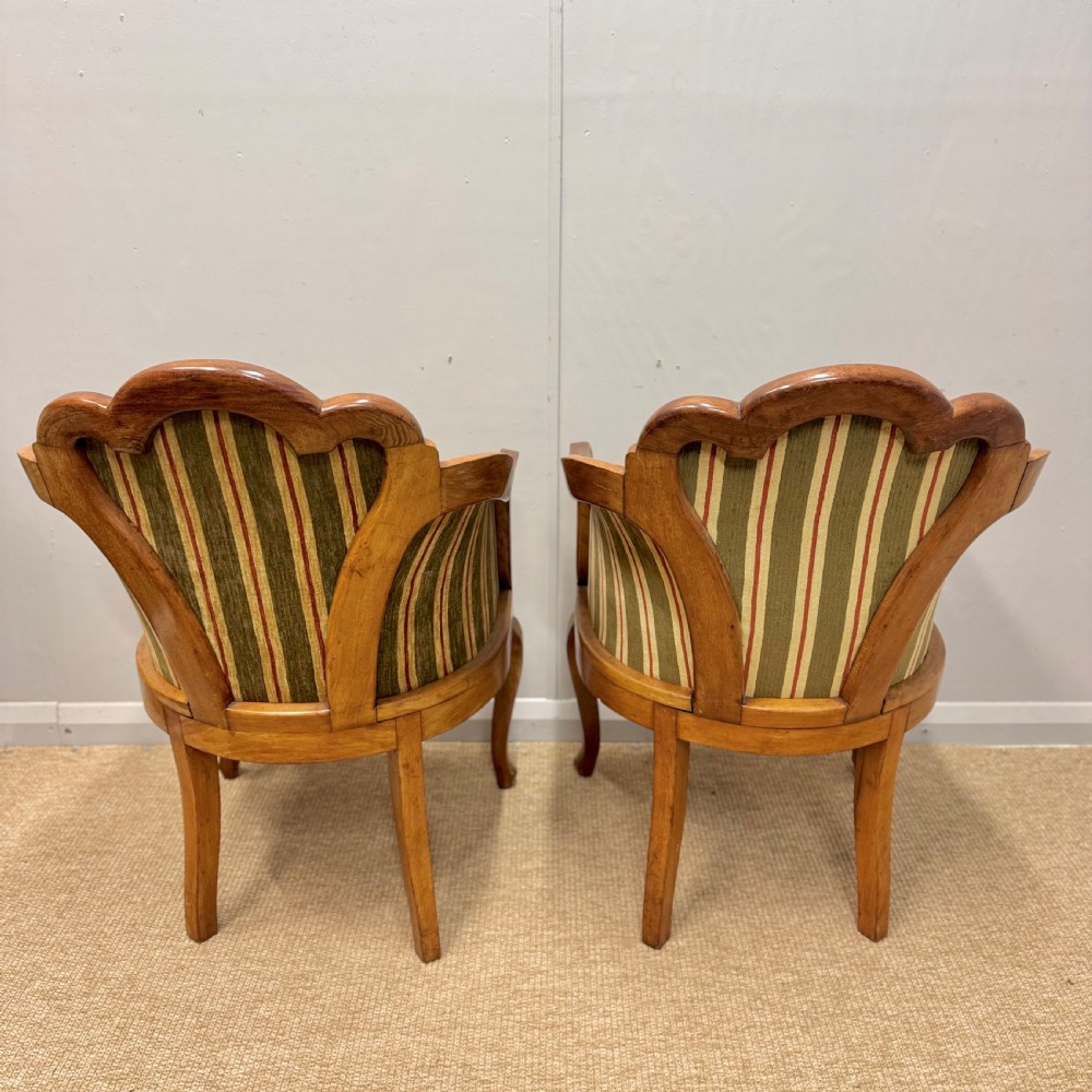 A pair of satinwood armchairs featuring hand-painted Chinoiserie detail, cabriole legs, and striped green, beige, and red fabric upholstery. View IX