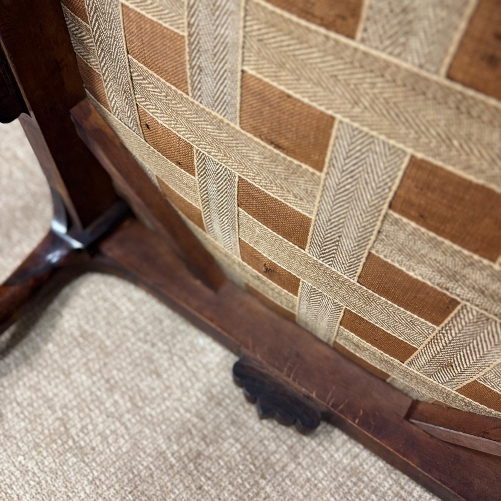 A low Victorian rosewood footstool featuring light green upholstery and hand-carved cabriole legs with scroll feet. View VII
