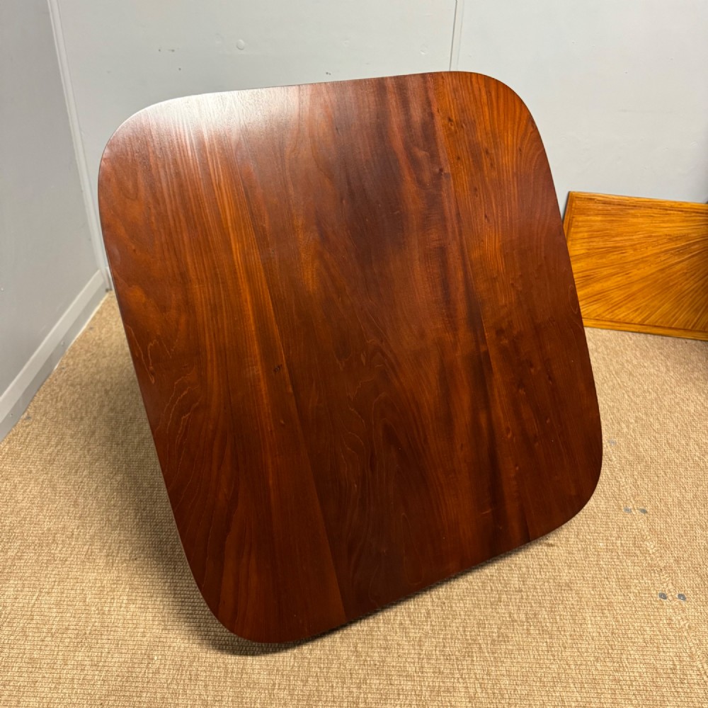 A low English Regency mahogany coffee table with a polished square top, rounded corners, a deep apron, and splayed legs with carved feet. View IV