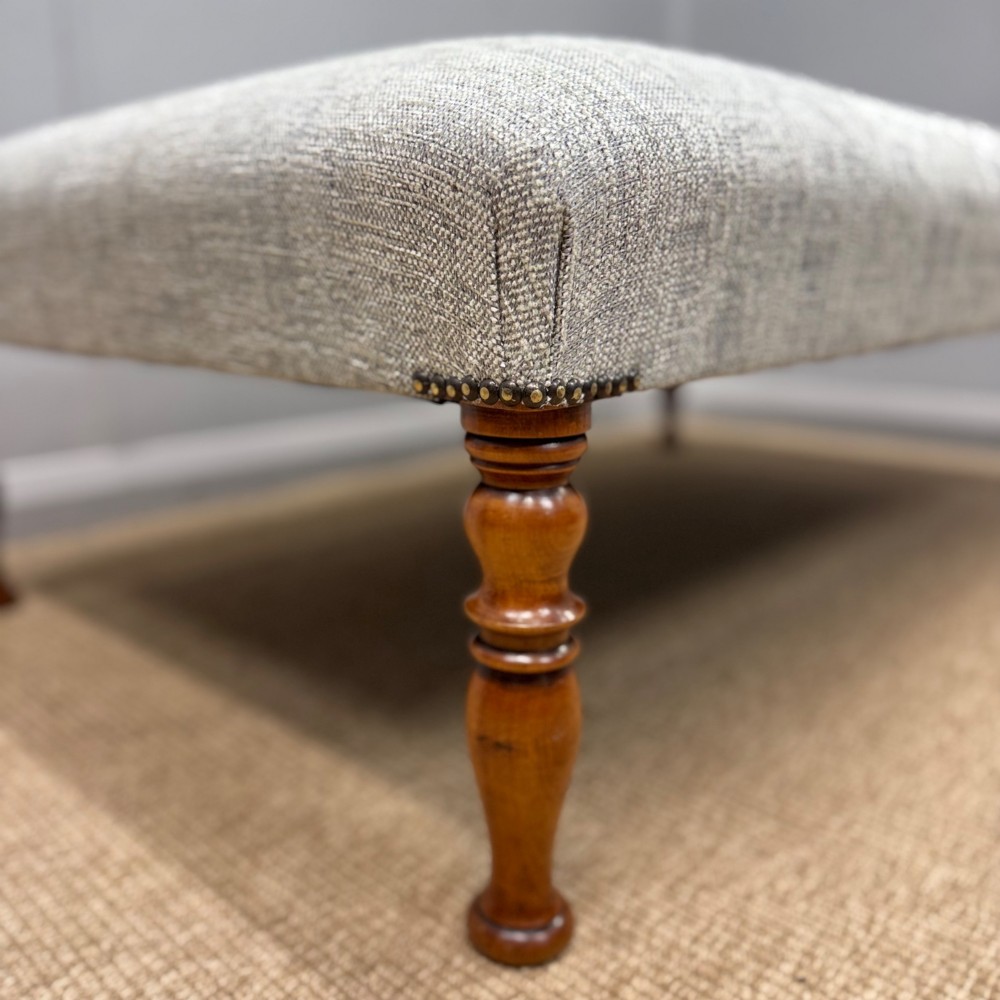 Newly upholstered large footstool View II