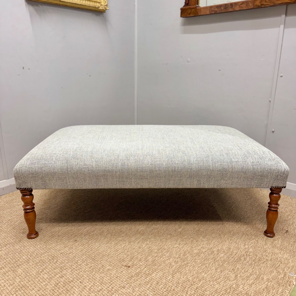 Newly upholstered large footstool View III