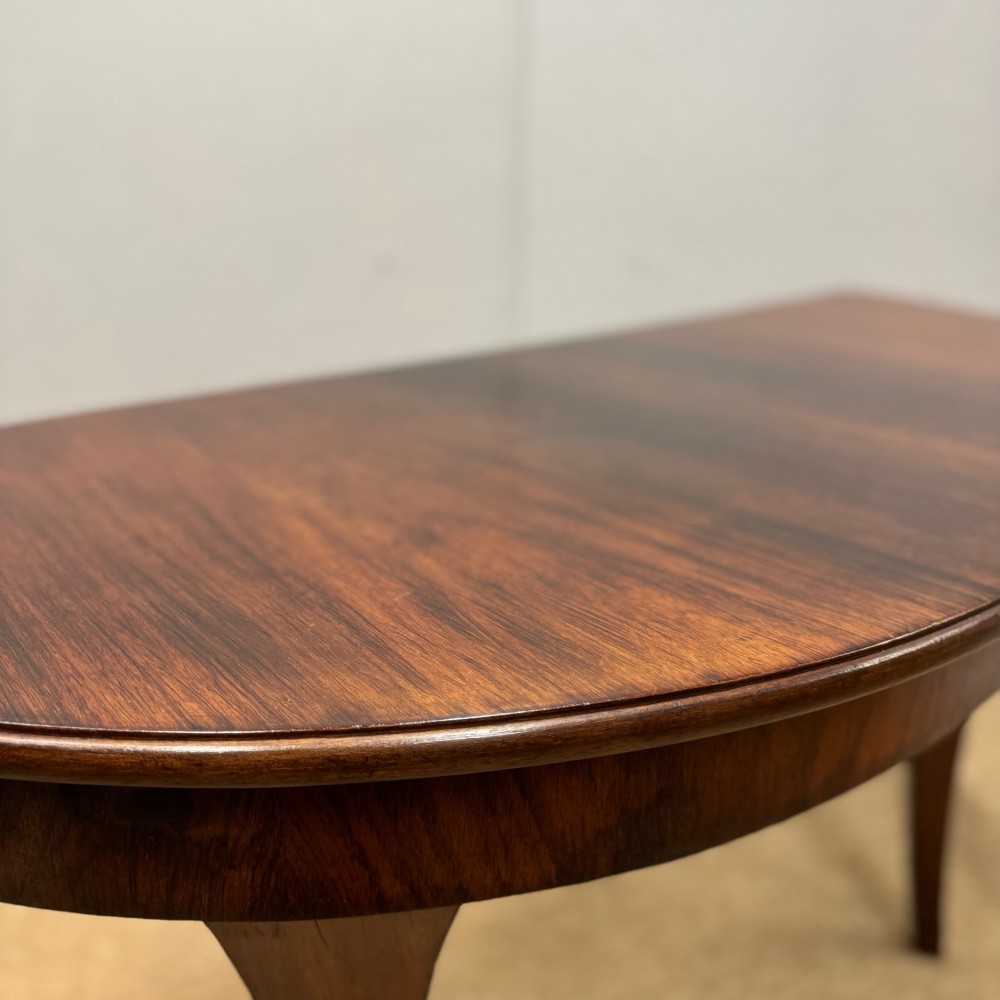 A 19th-century rosewood demilune console table featuring a semi-circular top, plain apron, and four sweeping concave legs. View VI