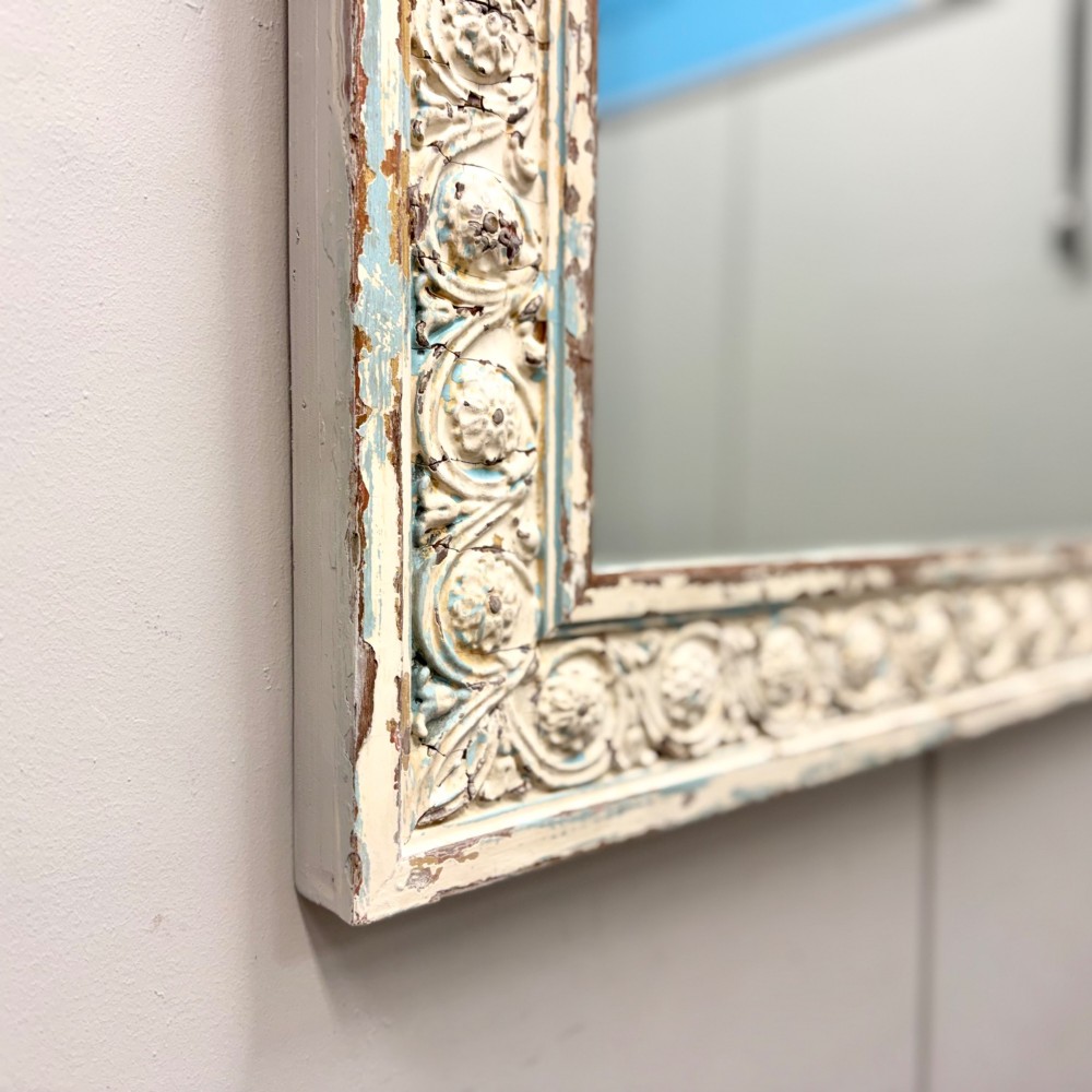 A rectangular 19th-century French overmantel mirror featuring a heavily carved rosette frame with distressed white paint. View V