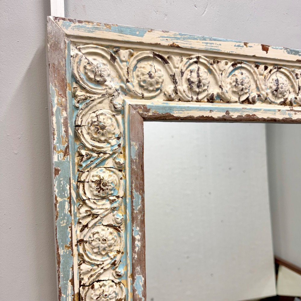 A rectangular 19th-century French overmantel mirror featuring a heavily carved rosette frame with distressed white paint. View VIII