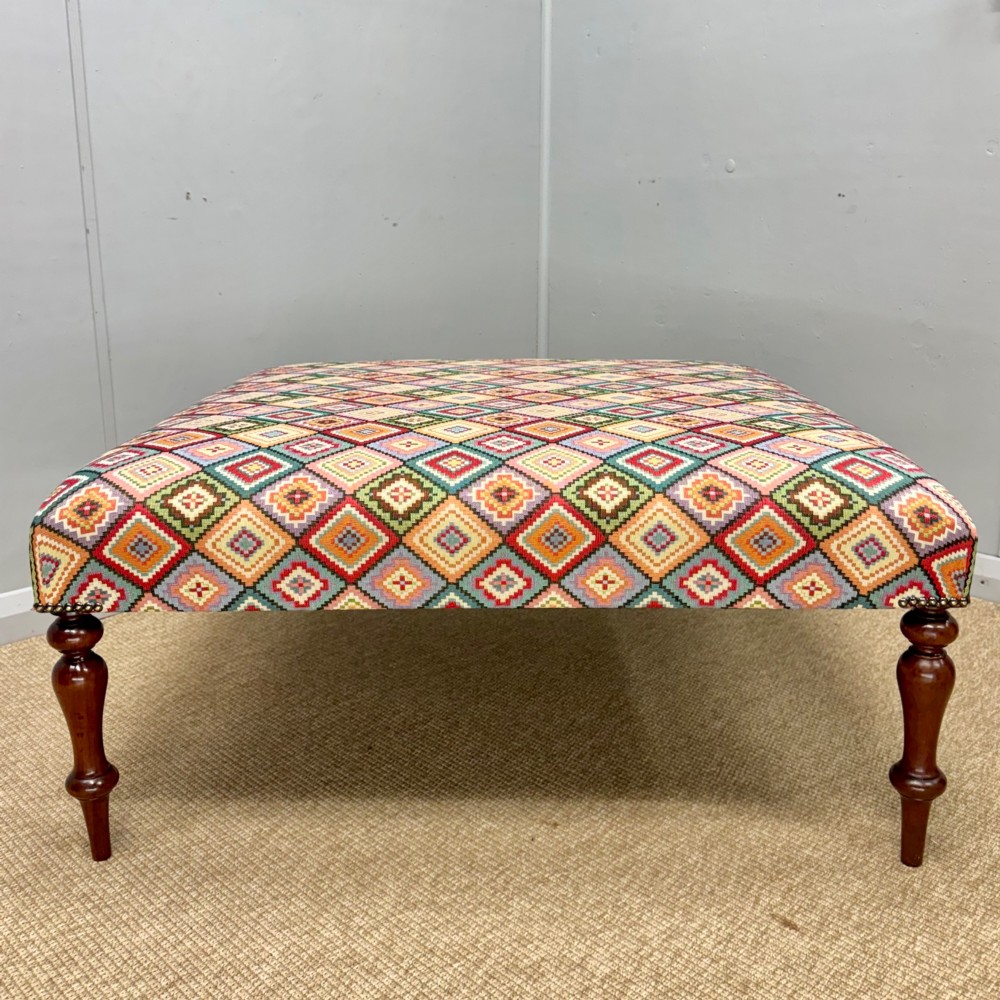 Newly upholstered 100cm square geometric pattern footstool