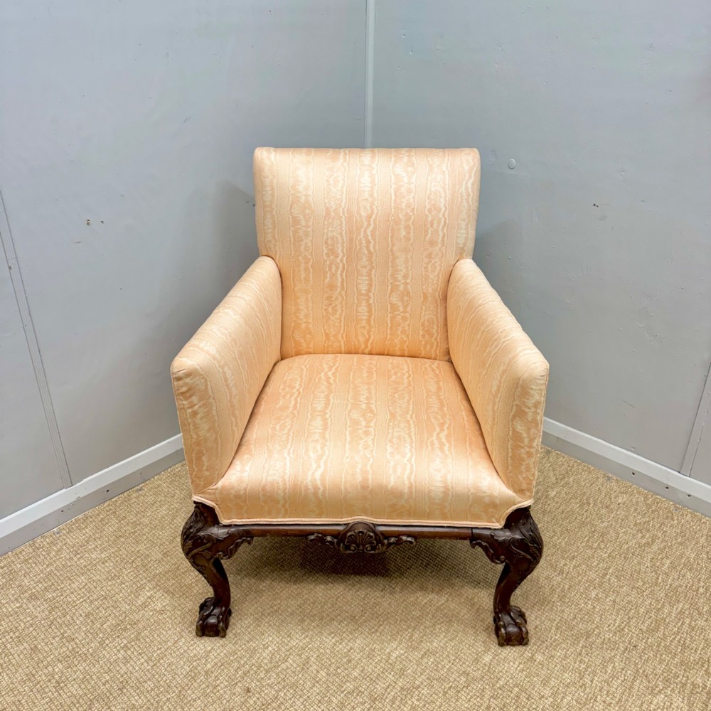 A Georgian armchair upholstered in pale peach damask fabric featuring carved mahogany hipped cabriole legs with claw and ball feet. View III