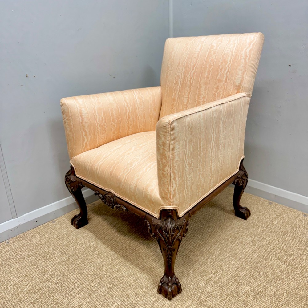 A Georgian armchair upholstered in pale peach damask fabric featuring carved mahogany hipped cabriole legs with claw and ball feet. View IV