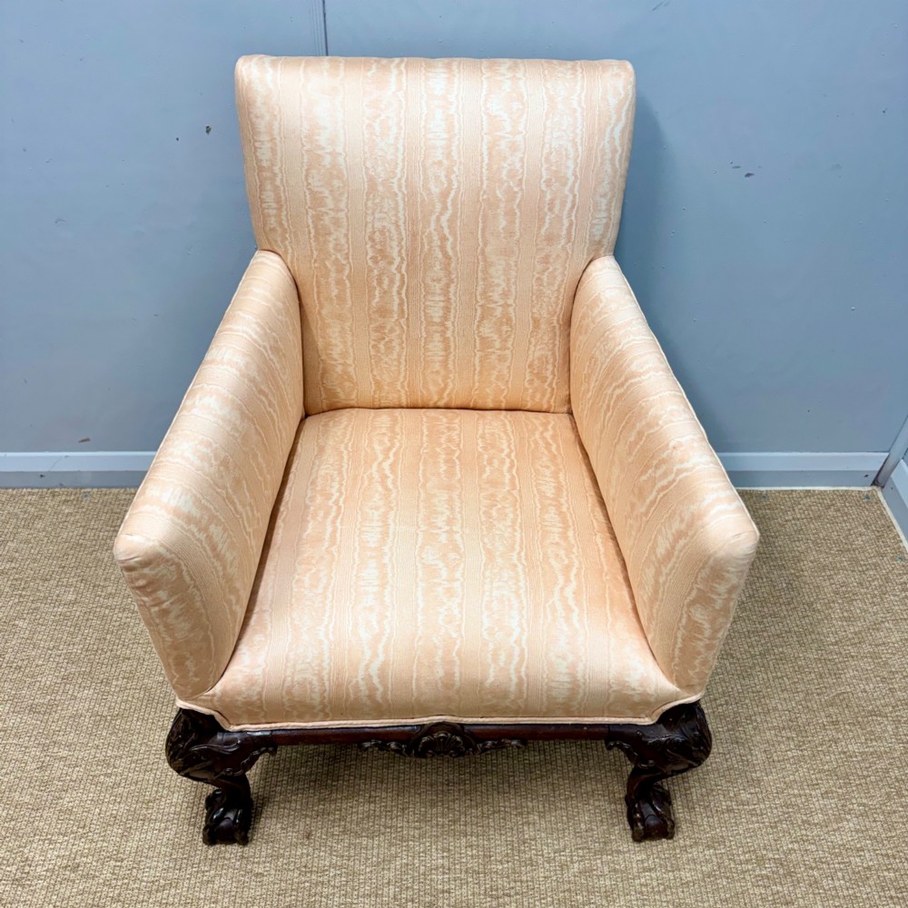 A Georgian armchair upholstered in pale peach damask fabric featuring carved mahogany hipped cabriole legs with claw and ball feet. View VI