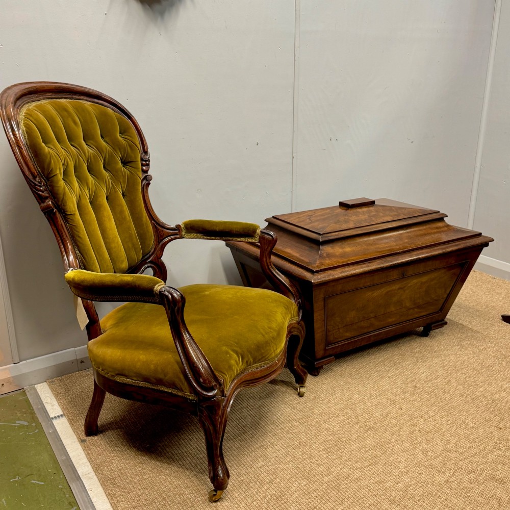 A late Georgian mahogany cellarette displaying a tapered sarcophagus shape with a stepped lid and flame mahogany panels. View III