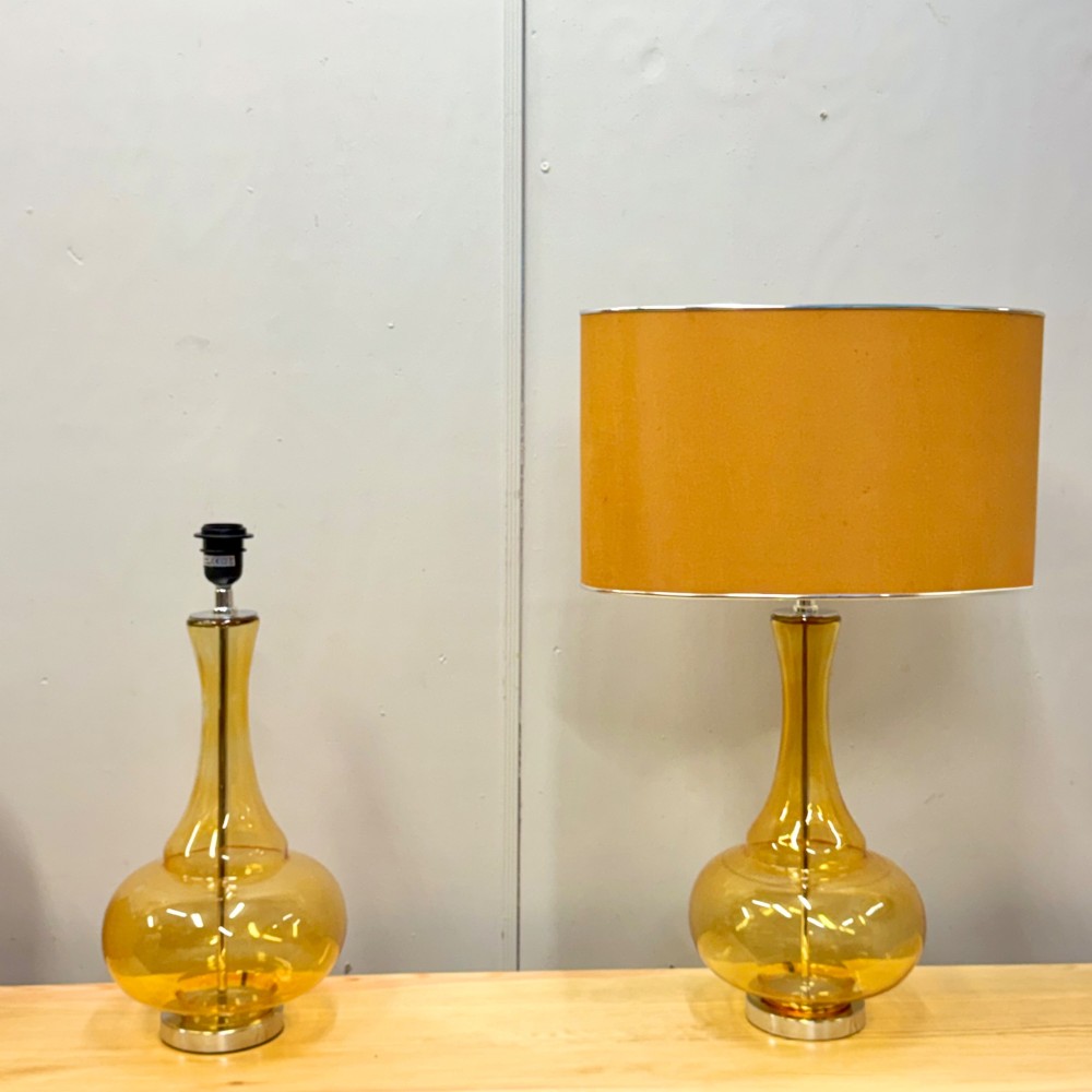 A pair of mid-century amber blown glass table lamps featuring slender necks, bulbous bases, and matching ochre drum shades. View III