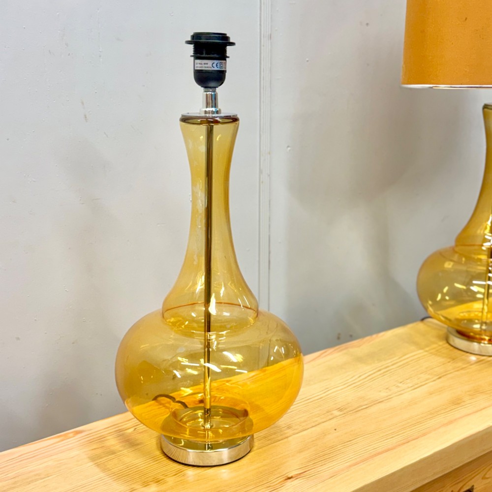 A pair of mid-century amber blown glass table lamps featuring slender necks, bulbous bases, and matching ochre drum shades. View IV