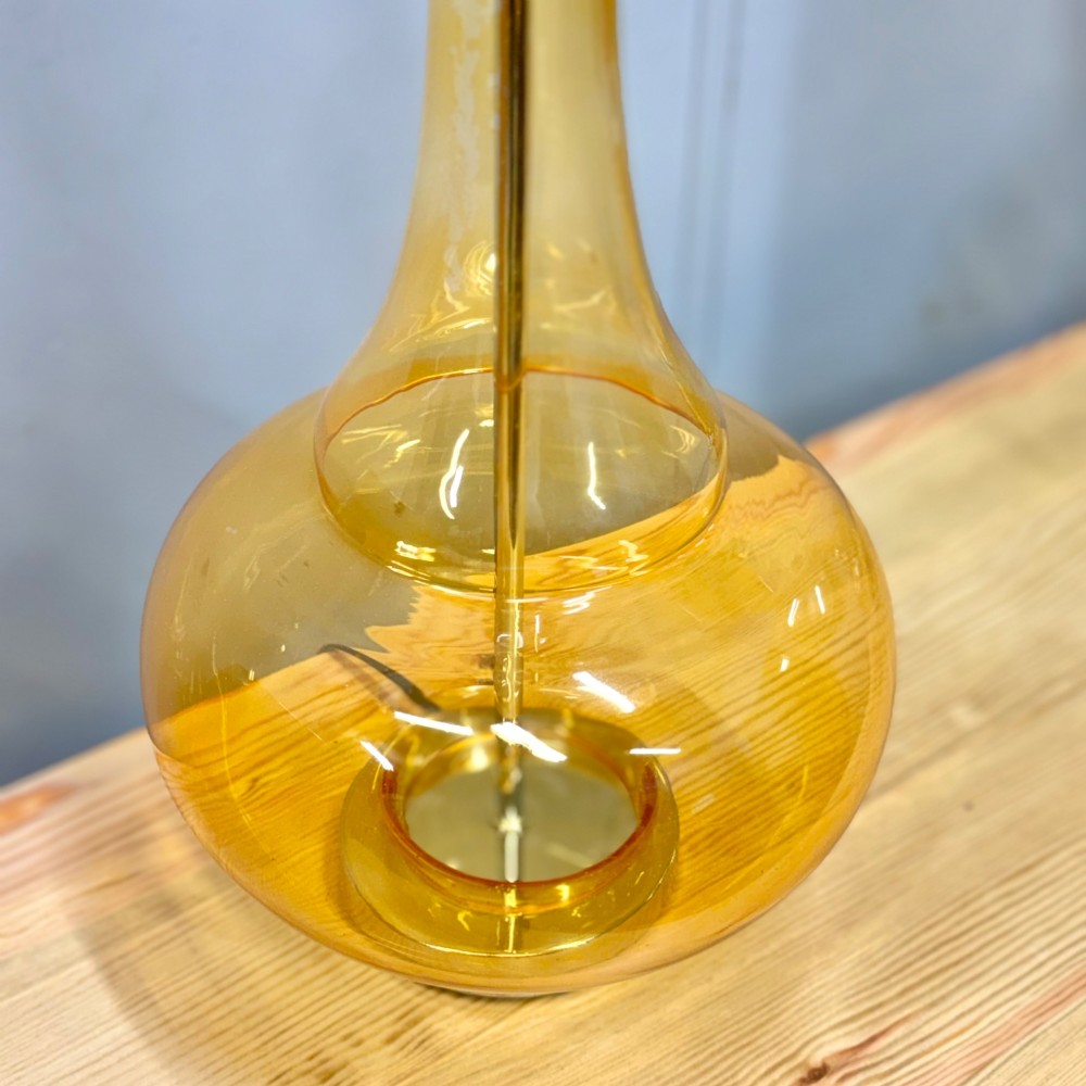 A pair of mid-century amber blown glass table lamps featuring slender necks, bulbous bases, and matching ochre drum shades. View VI