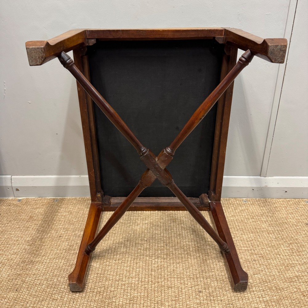 A rectangular mahogany dressing stool with a turned cross stretcher and cream lattice patterned tapestry upholstery. View V