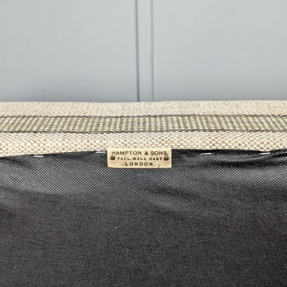 An Edwardian rectangular satinwood piano stool upholstered in beige striped fabric with square tapered legs. View VI